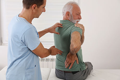 Oasis Wellness Partners - Senior Getting Chiropractic Adjustment